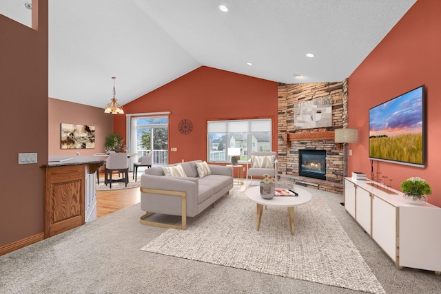 carpeted living room featuring a fireplace, a textured ceiling, high vaulted ceiling, and an inviting chandelier