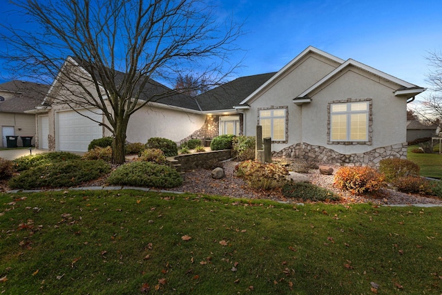 view of front of home featuring a garage and a front lawn