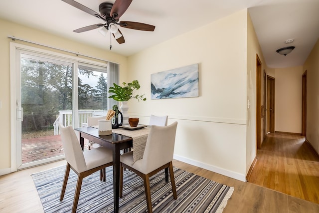 dining room with hardwood / wood-style flooring and ceiling fan