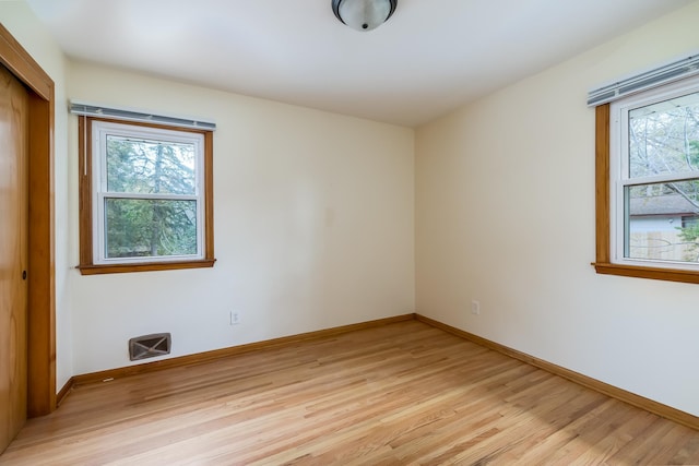 unfurnished room with light hardwood / wood-style flooring