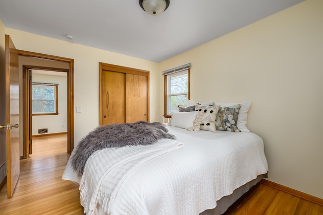 bedroom featuring light wood-type flooring and a closet