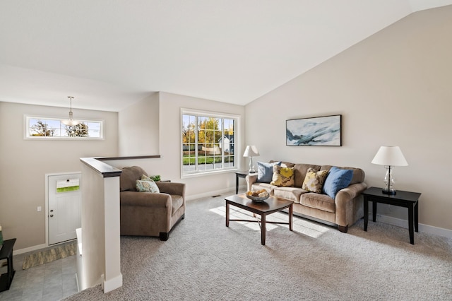 carpeted living room featuring a chandelier and lofted ceiling