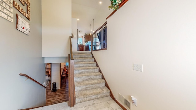 stairway featuring tile patterned flooring