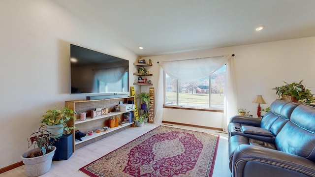 living room with lofted ceiling and light hardwood / wood-style flooring