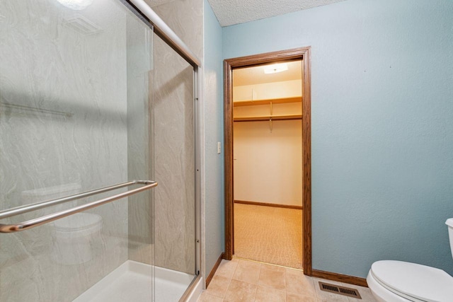 full bath featuring toilet, a stall shower, and visible vents