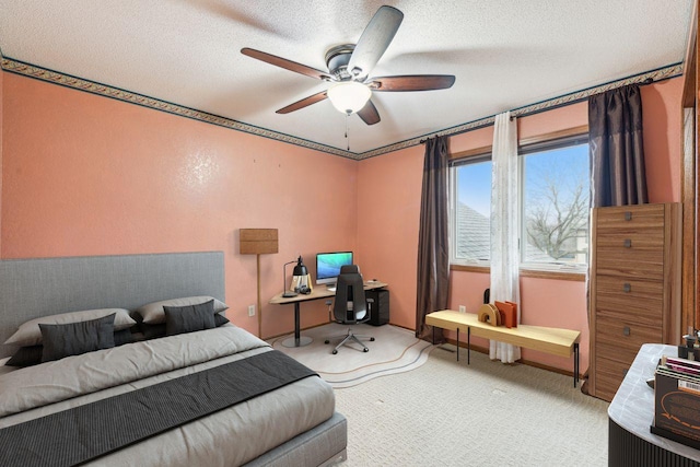 bedroom with a textured ceiling, ceiling fan, and carpet flooring