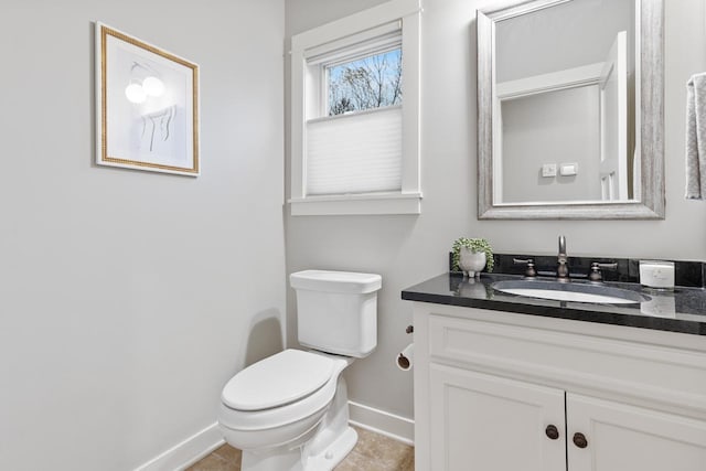 bathroom with toilet, tile patterned floors, and vanity