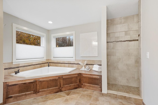 bathroom featuring tile patterned flooring and plus walk in shower