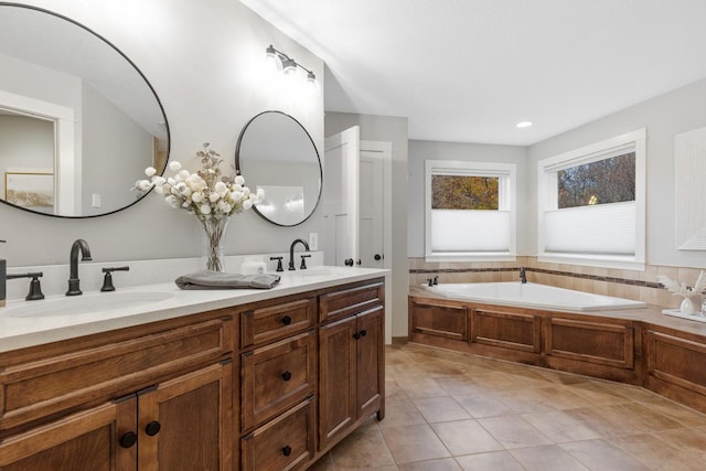 bathroom with vanity, tile patterned flooring, and a bath