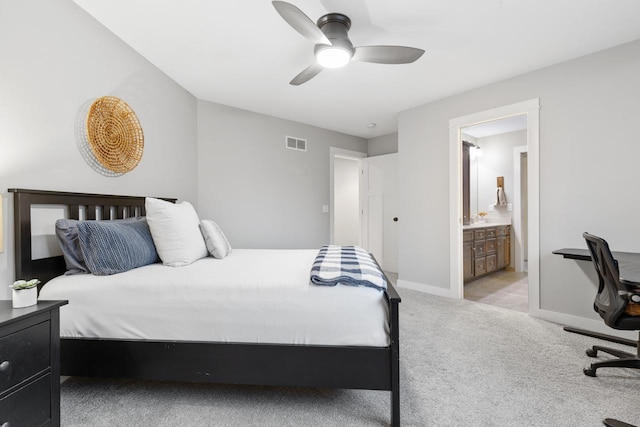 bedroom featuring light carpet, ceiling fan, and connected bathroom