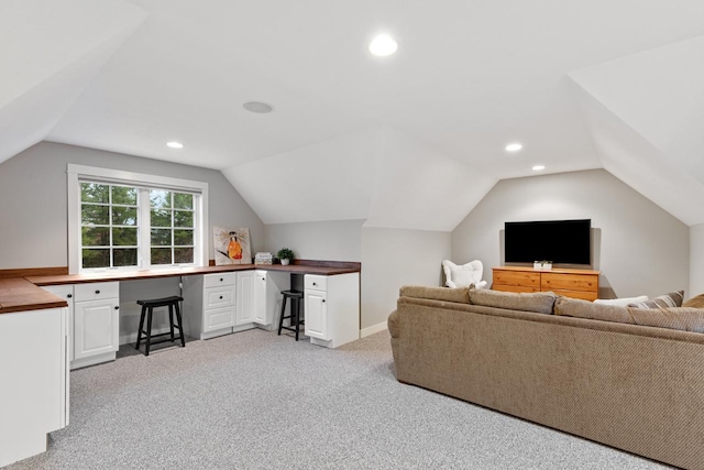 carpeted living room with vaulted ceiling