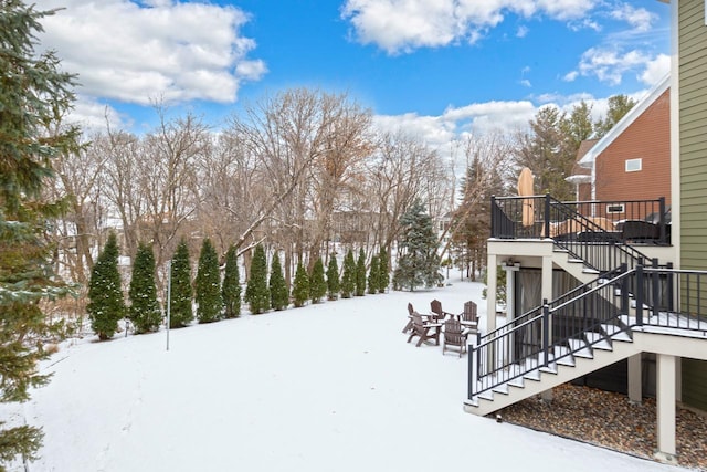 yard layered in snow featuring an outdoor fire pit