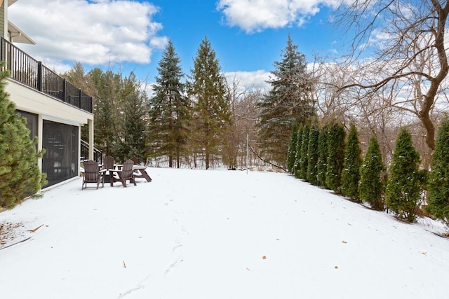 snowy yard with a balcony