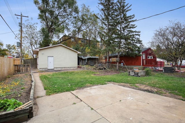 view of yard featuring an outbuilding and a patio