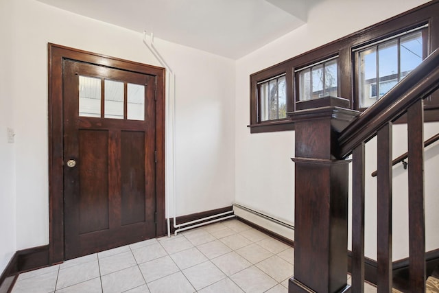 entrance foyer with a baseboard heating unit and light tile patterned floors