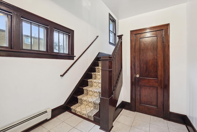 staircase with tile patterned flooring and a baseboard heating unit