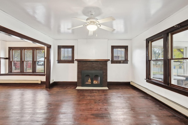 unfurnished living room featuring a brick fireplace, a baseboard radiator, ceiling fan, and dark hardwood / wood-style flooring