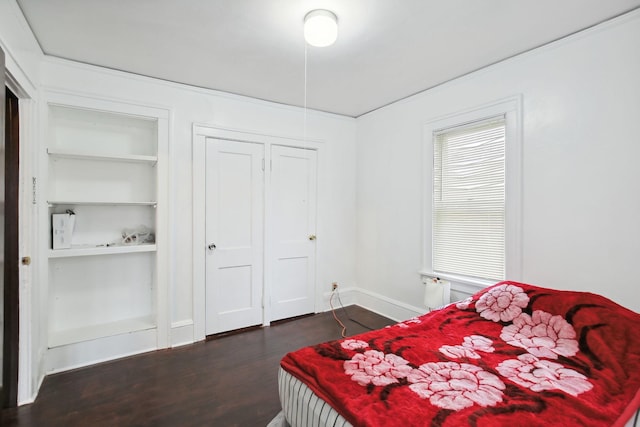 bedroom with dark wood-type flooring