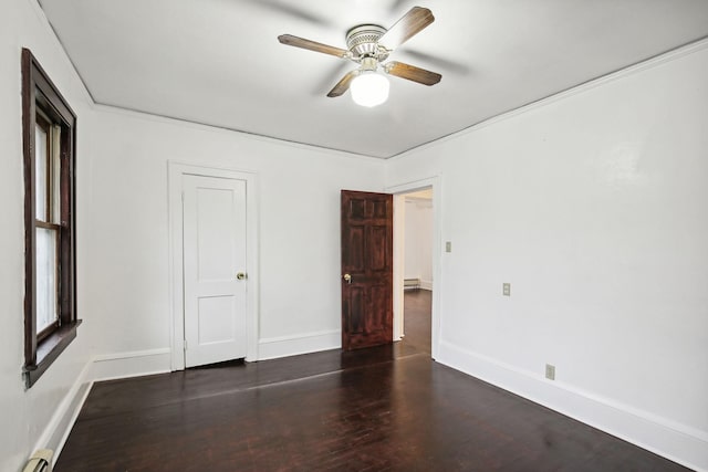 unfurnished bedroom featuring dark wood-type flooring, baseboard heating, and ceiling fan