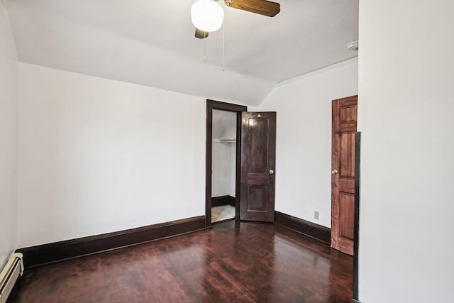 unfurnished room with ceiling fan, vaulted ceiling, dark hardwood / wood-style floors, and a baseboard radiator