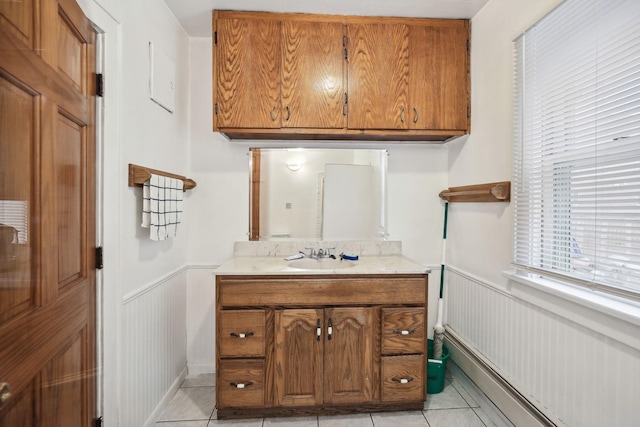 bathroom featuring a baseboard heating unit, vanity, and tile patterned floors