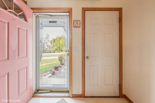 doorway to outside featuring light tile patterned floors