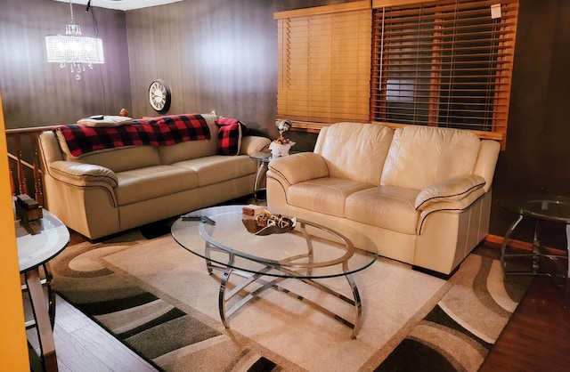 living room with hardwood / wood-style flooring and a chandelier