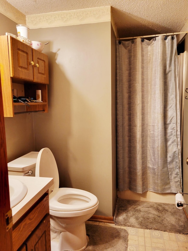 bathroom featuring vanity, a textured ceiling, toilet, and a shower with curtain