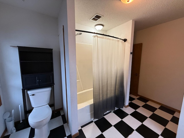 bathroom with shower / bath combo, toilet, and a textured ceiling