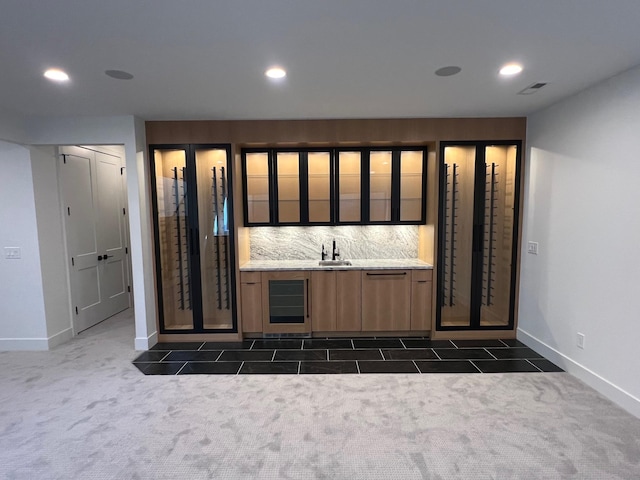 wine cellar with baseboards, dark colored carpet, indoor wet bar, and recessed lighting