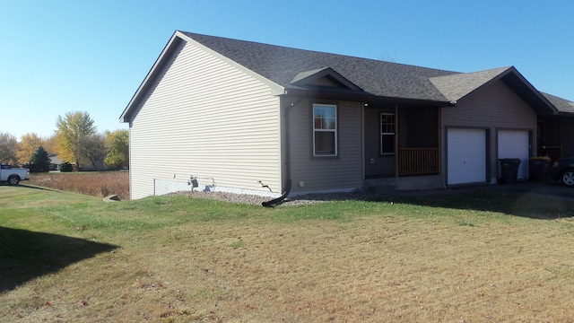 exterior space featuring a garage and a front lawn