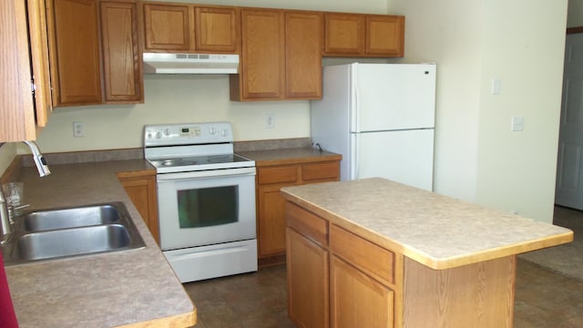 kitchen with a center island, white appliances, and sink