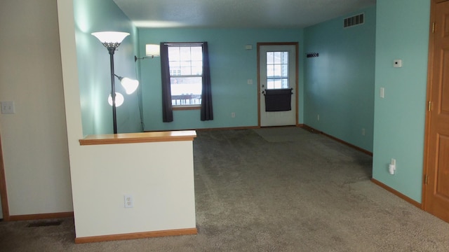 view of carpeted foyer entrance