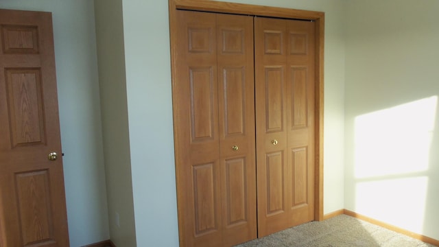 carpeted bedroom with a closet