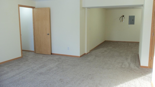 unfurnished room featuring light carpet and electric panel