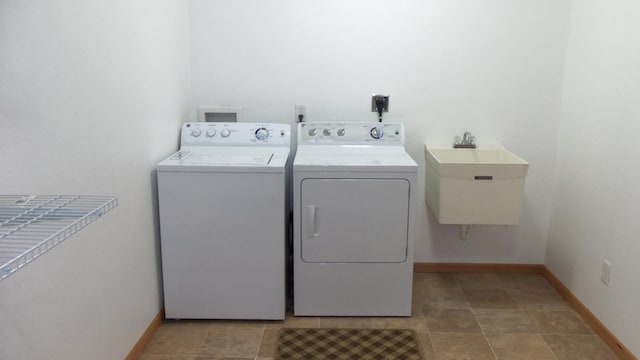 washroom with washer and dryer and sink