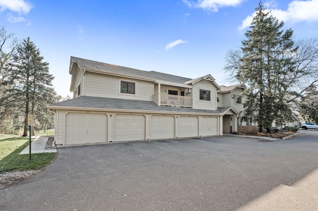 view of front of home featuring a balcony and a garage