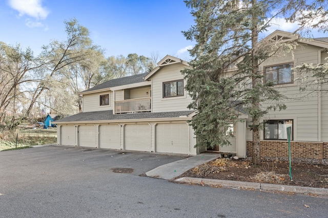 view of front of house featuring a garage and a balcony