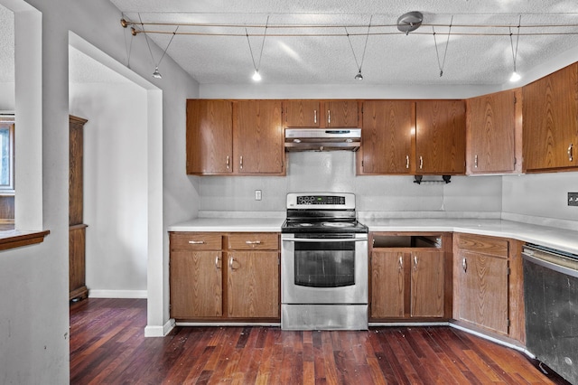 kitchen featuring dark wood-type flooring, stainless steel appliances, and a textured ceiling