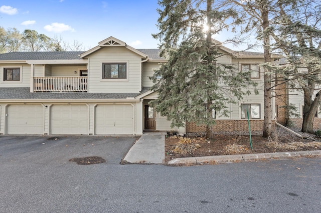 multi unit property with a garage and a balcony