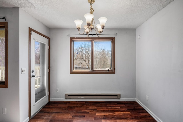 unfurnished dining area featuring a baseboard radiator, a textured ceiling, baseboards, and wood finished floors