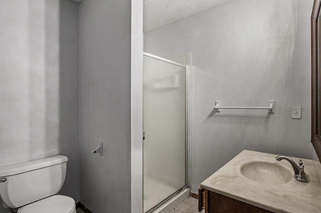 bathroom with toilet, a stall shower, a textured ceiling, and vanity