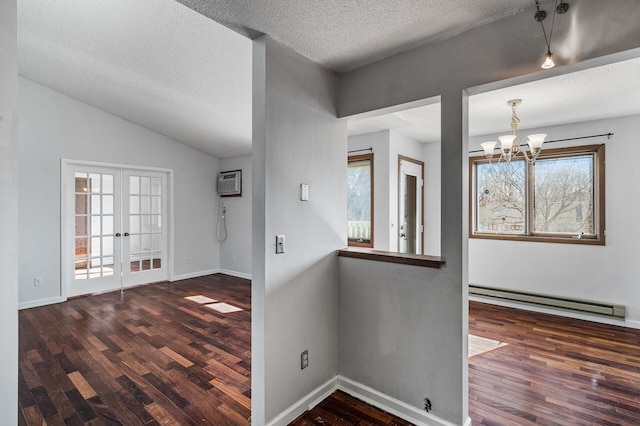 foyer entrance featuring an AC wall unit, a baseboard radiator, wood finished floors, and french doors