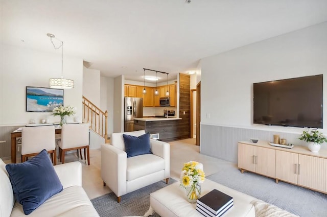 carpeted living room with wooden walls