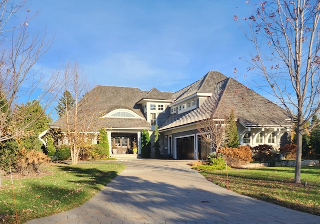 view of front of property with a front lawn and a garage