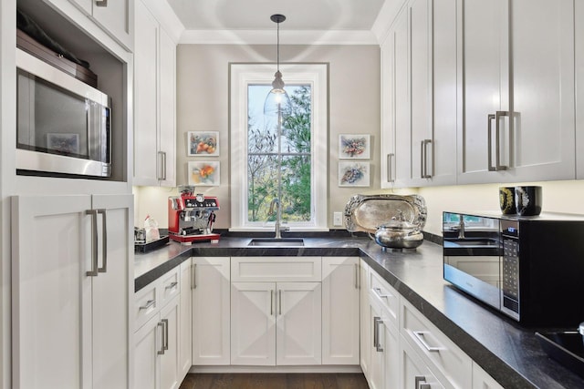 kitchen with white cabinets, pendant lighting, dark hardwood / wood-style flooring, and sink