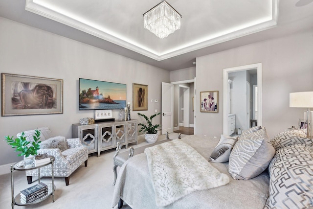 bedroom featuring a notable chandelier, a raised ceiling, and light carpet