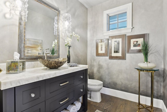 bathroom featuring hardwood / wood-style floors, vanity, and toilet