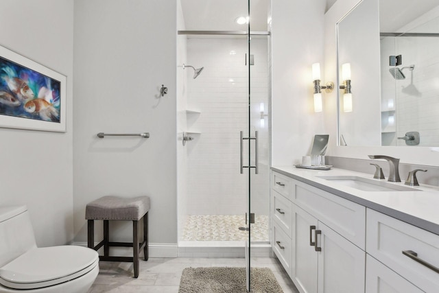 bathroom with toilet, an enclosed shower, and vanity