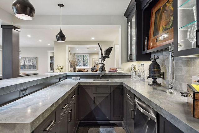 kitchen with sink, hanging light fixtures, stainless steel dishwasher, kitchen peninsula, and decorative backsplash